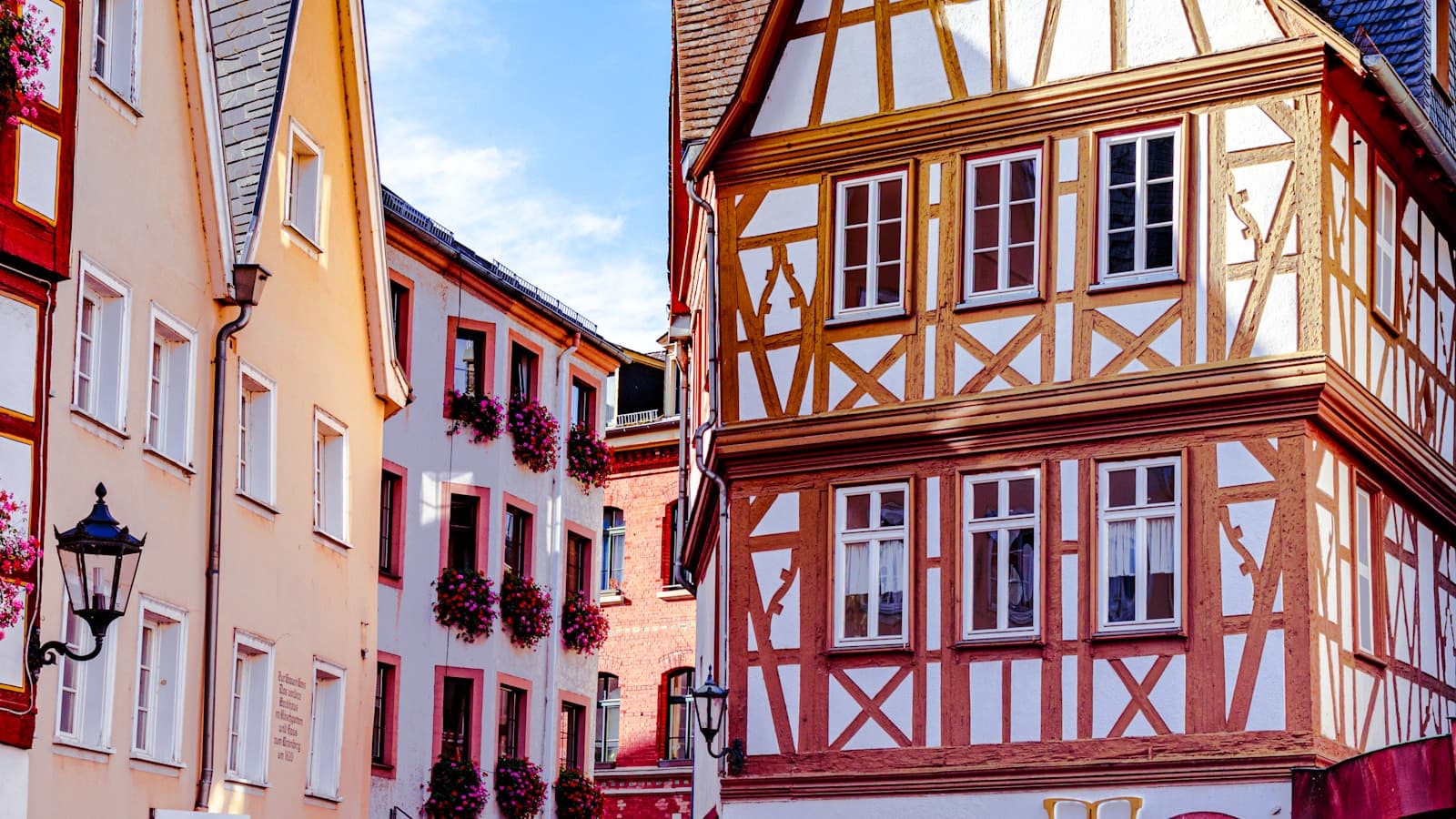 A cobblestone street lined with tall historic European buildings.