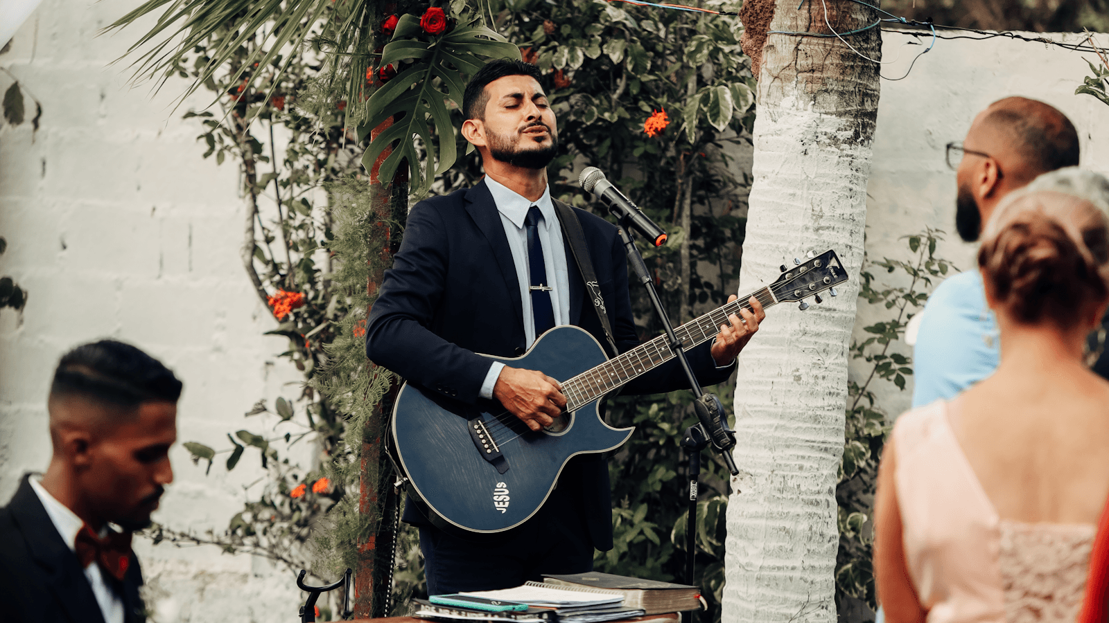 A guitarist performing in front of an audience.