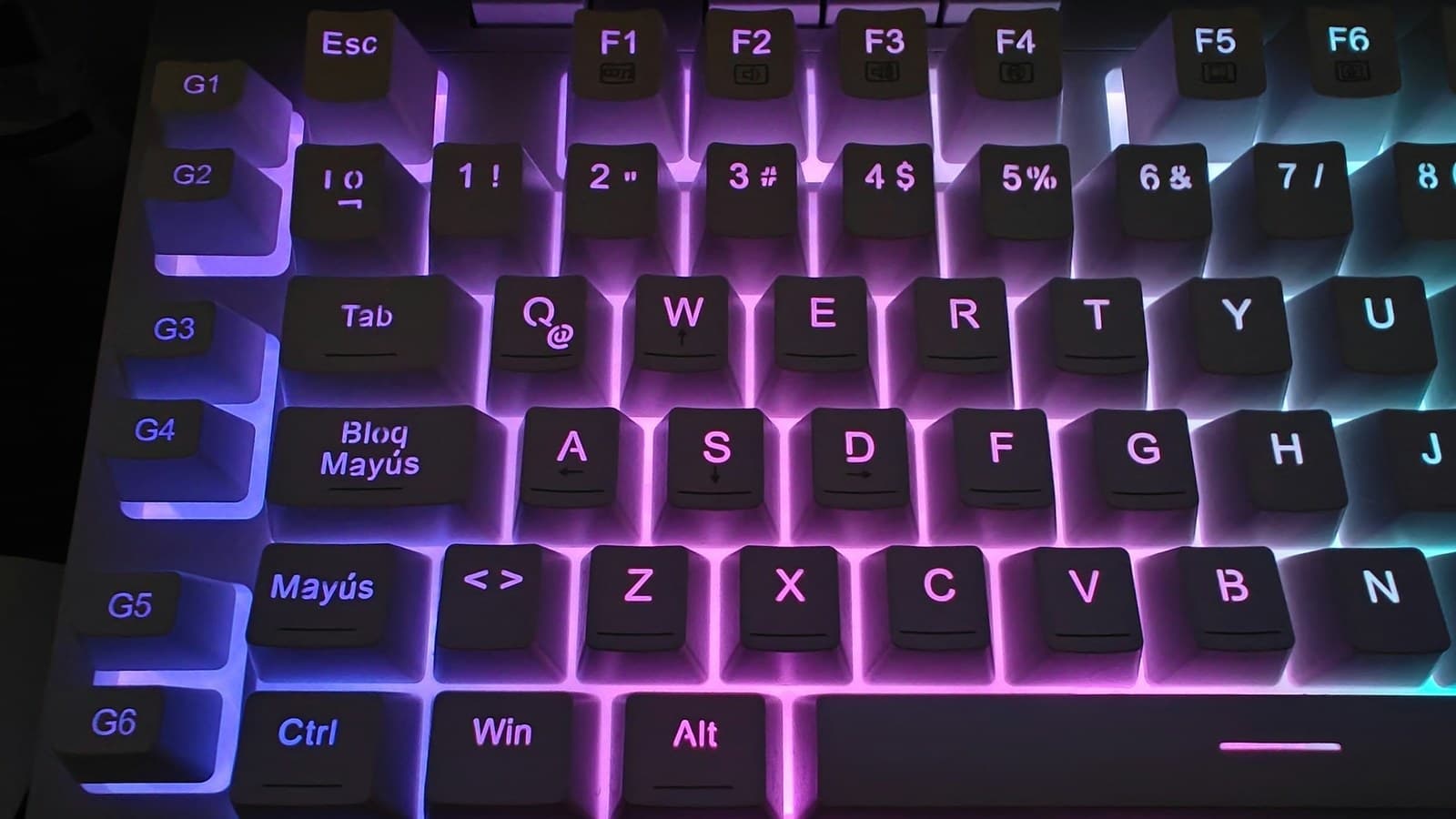 A close-up of a keyboard lit with colorful RGB backlighting, no readable text or logos.