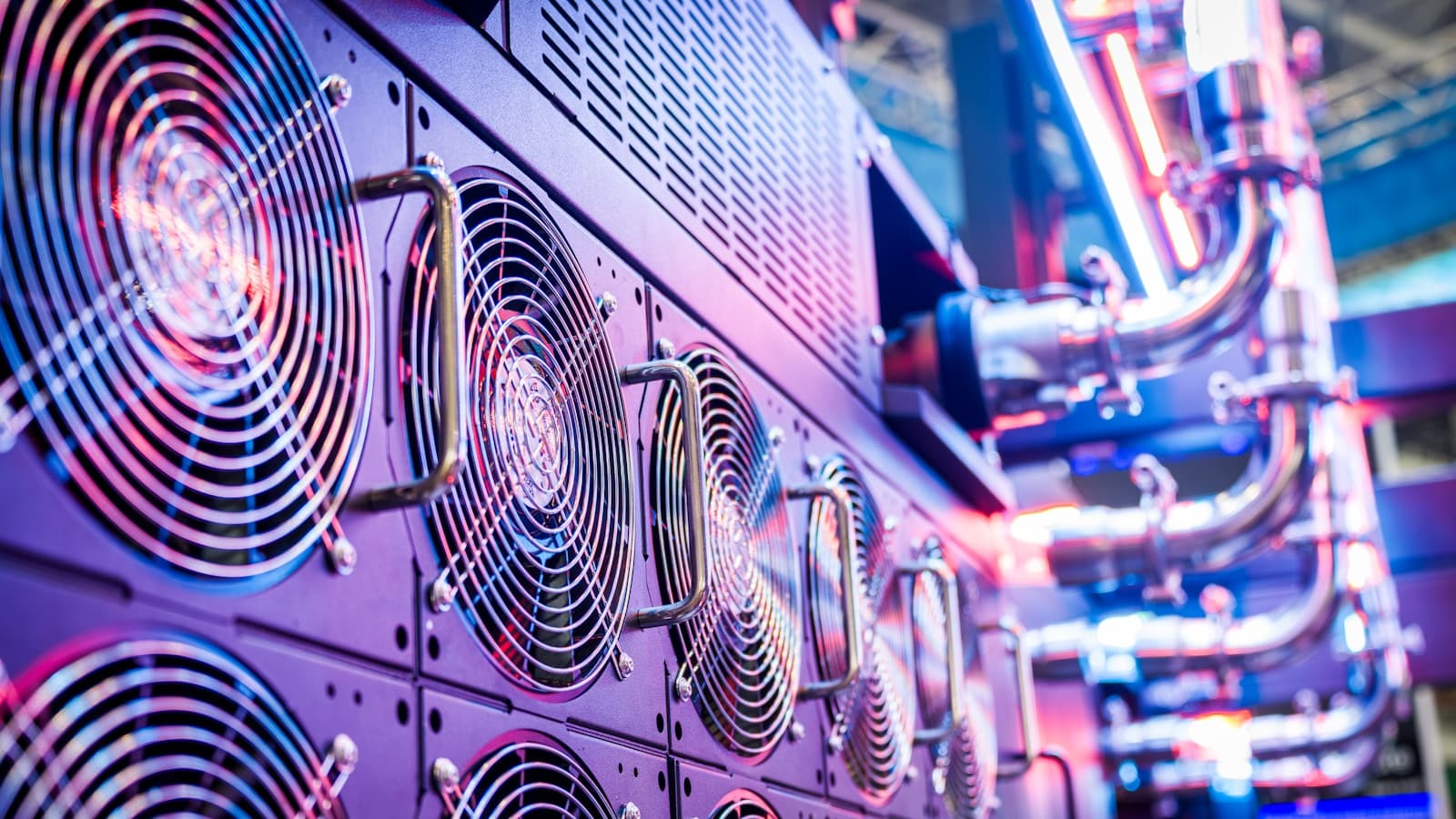 A dramatic close-up of server cooling fans lit in purple and blue.