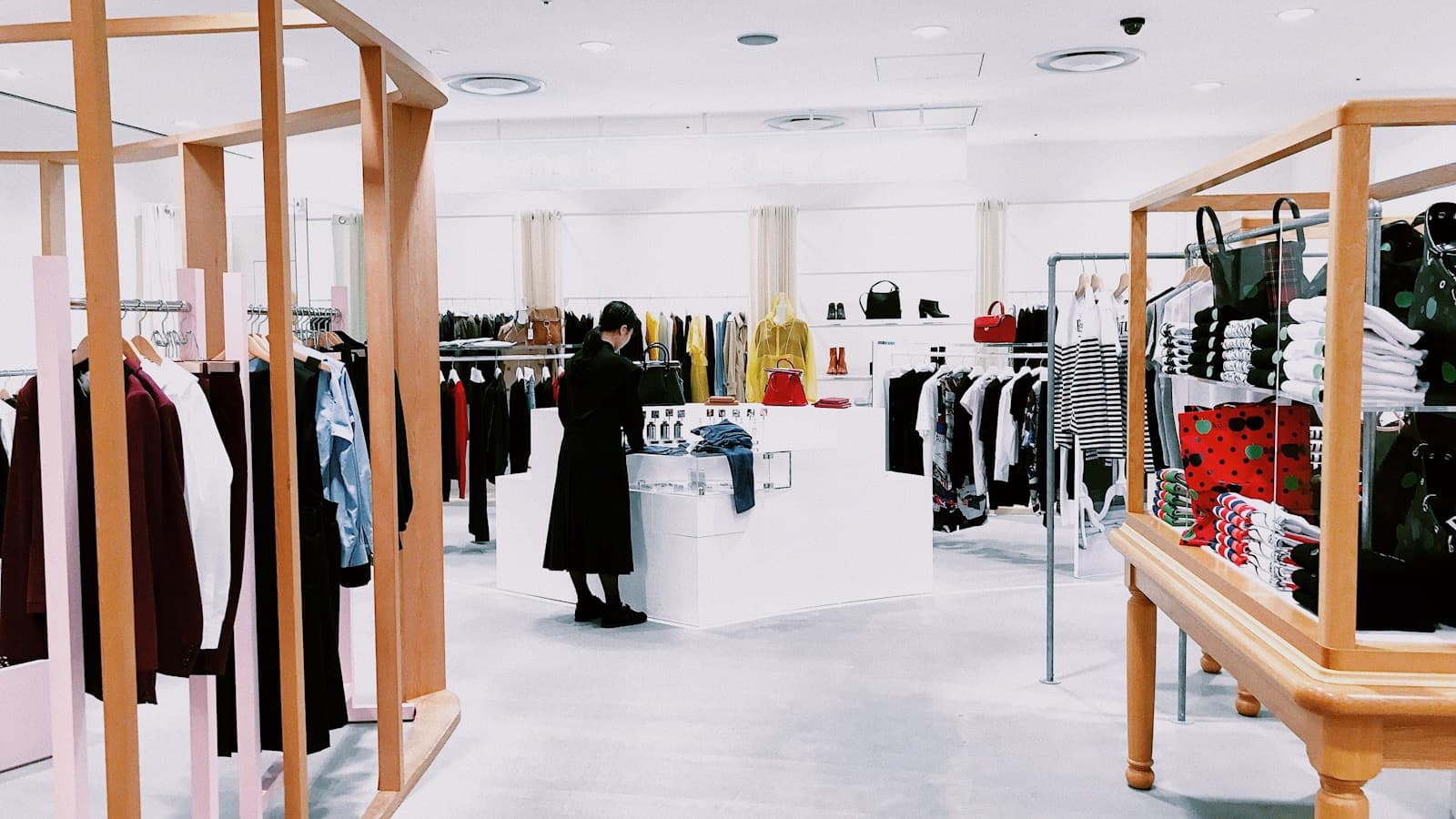 Overhead view of a woman selecting clothes in a modern boutique.