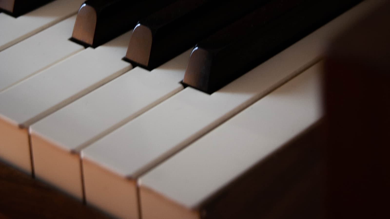 A close-up of black and white piano keys at an angle, no fallboard or brand name visible, no people.