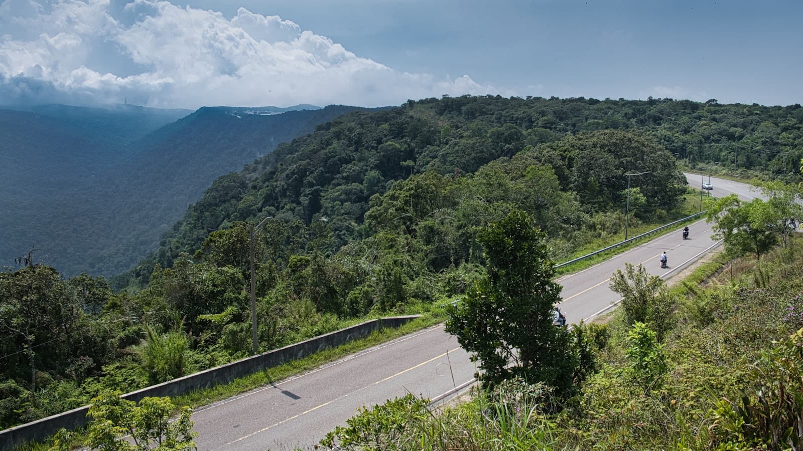A motorcyclist riding a scenic mountain road.