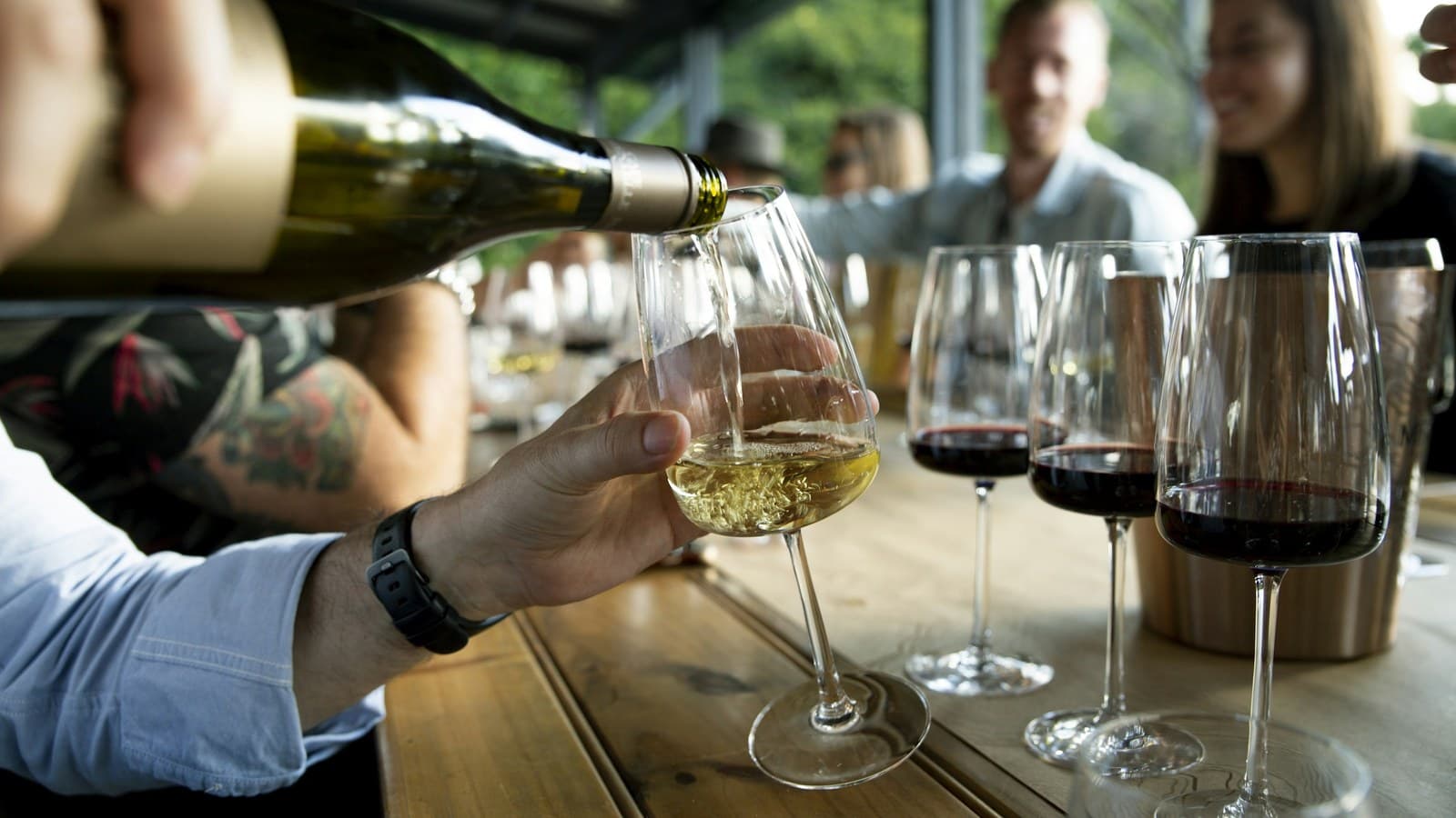 A group of people seated together at a table, each with a glass of wine.