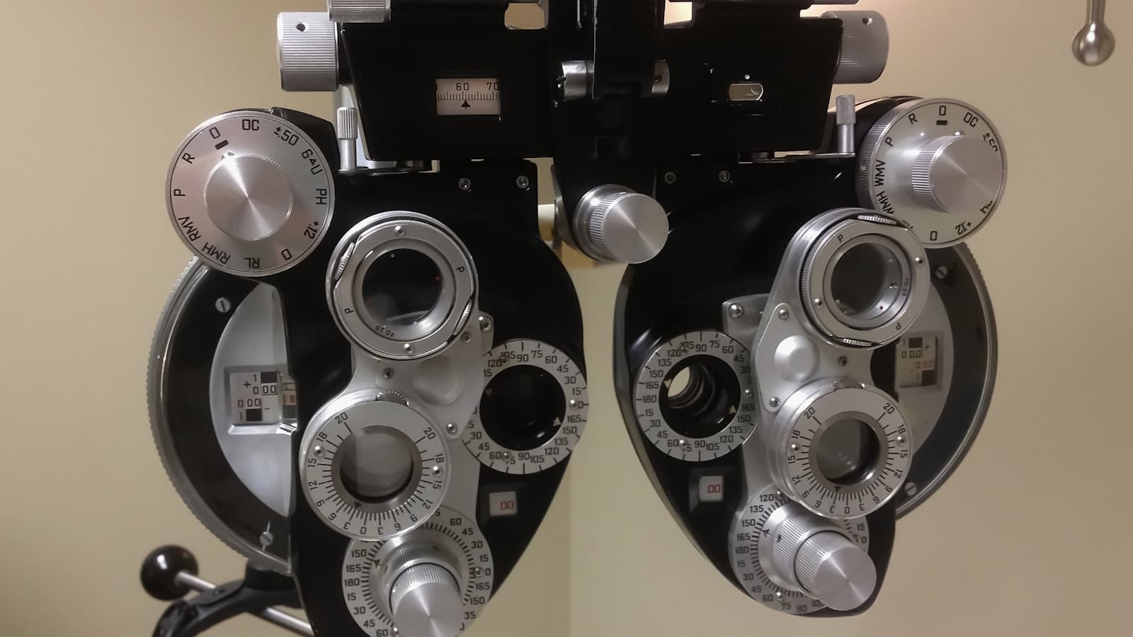 Close-up of a modern phoropter (eye exam refractor) device.