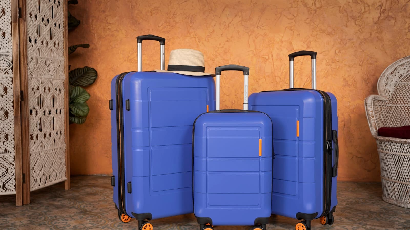 Three blue suitcases arranged together for travel.