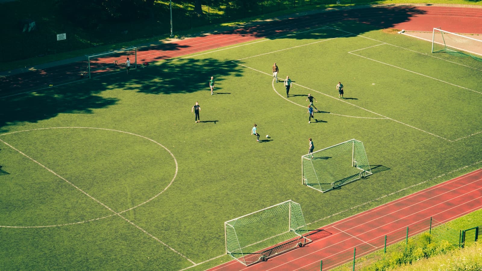 An aerial view of a youth soccer match on a full field.